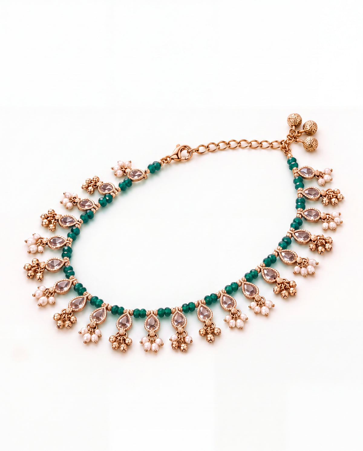Bloom Drop green anklet laid in an oval with clear teardrop stones, green beads and pearl and bell tassels