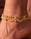 Ava Pearl anklets close-up with textured paisley details, pearl-like bead fringe, clear accents, and bell charms