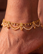 Ava Pearl anklets close-up with textured paisley details, pearl-like bead fringe, clear accents, and bell charms