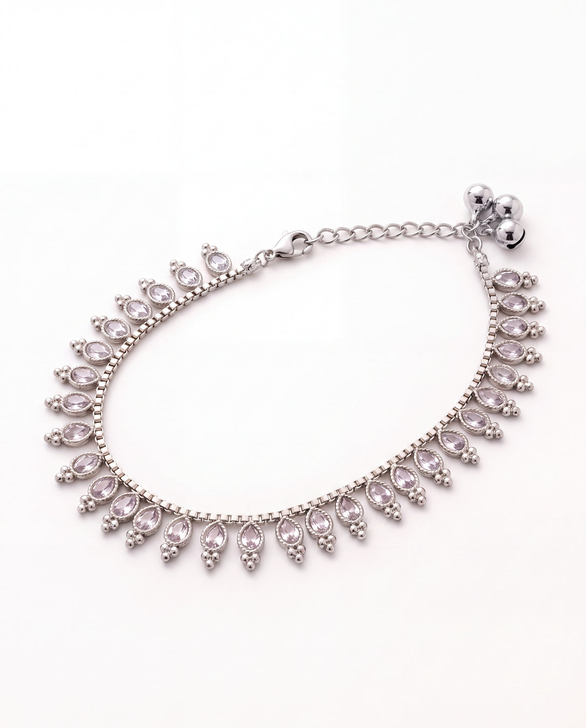 Margot Chime silver-tone anklet laid in an oval with a fringe of clear oval stones and three small bells