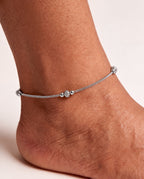 Luma Frost silver-tone anklet worn on an ankle with a small textured bead station