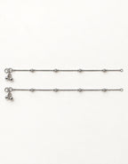 Pair of Luma Frost silver-tone anklets laid flat with four small textured bead stations on each anklet