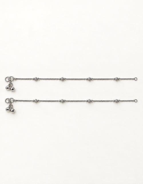Pair of Luma Frost silver-tone anklets laid flat with four small textured bead stations on each anklet