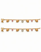 Marigold Bloom matching gold-tone anklet pair laid flat with elephant charms and pink and teal accents