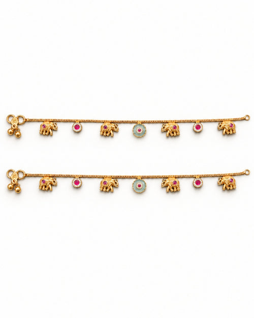 Marigold Bloom matching gold-tone anklet pair laid flat with elephant charms and pink and teal accents