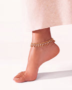 Margot Chime gold-tone anklet worn on a raised ankle