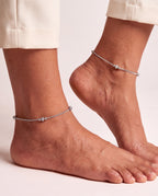 Pair of Luma Frost silver-tone anklets worn on both ankles with small textured bead stations