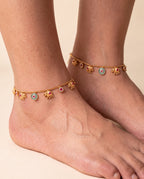 Marigold Bloom anklet pair worn on both ankles showing the elephant charms and colored accents