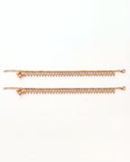 Margot Chime gold-tone anklet pair laid flat, showing the lobster clasp and extension chain
