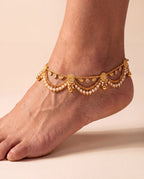 Ava Pearl anklet worn on one ankle showing the paisley details, pearl-like fringe, and bells