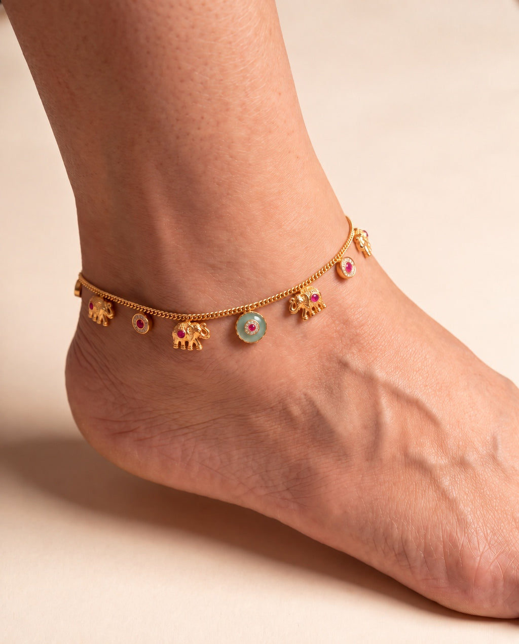 Marigold Bloom anklet worn on one ankle with elephant charms and a teal center accent