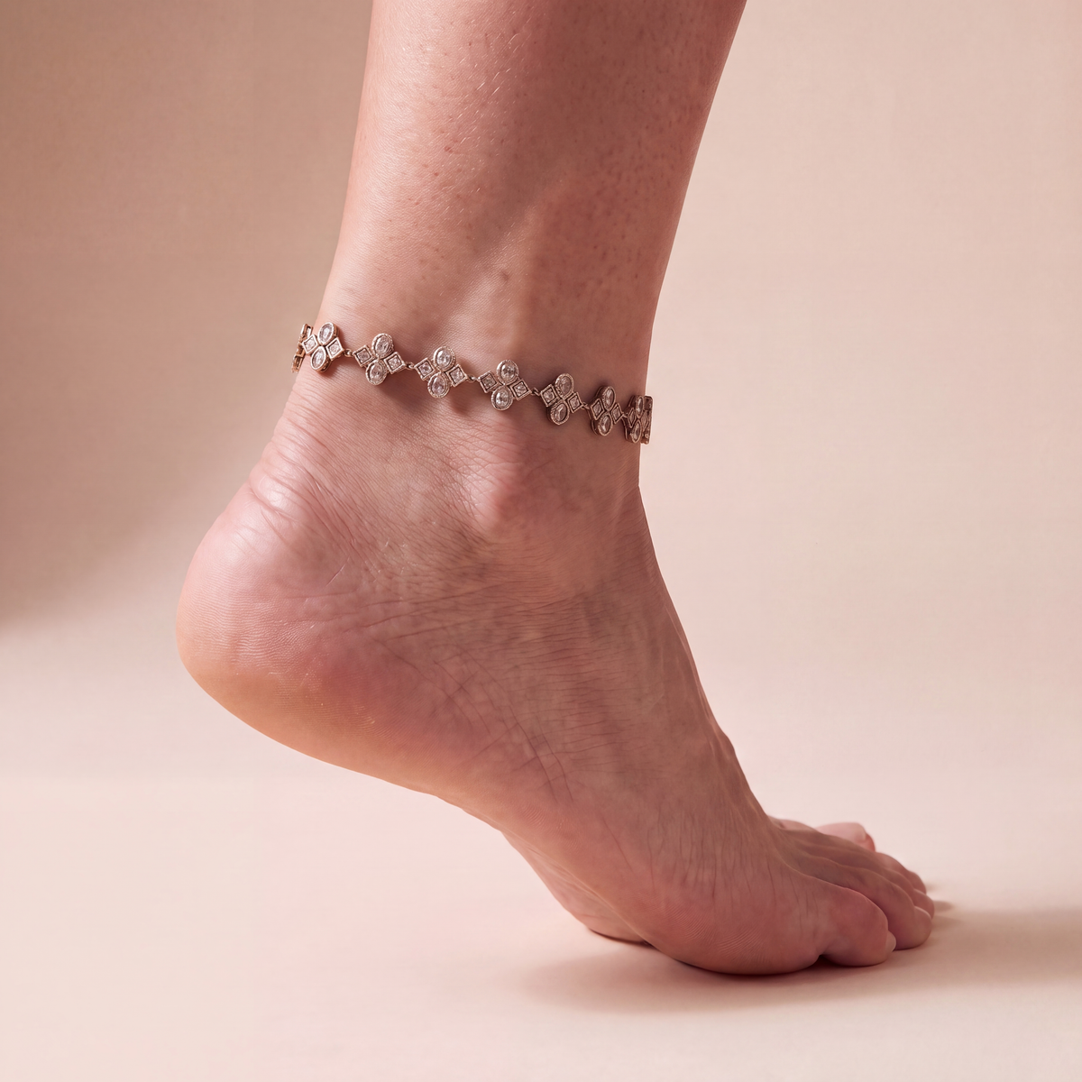 Starlight Bronze Anklets worn on one ankle, antique gold-tone geometric links with clear-stone clusters