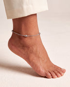 Luma Frost silver-tone anklet worn on one ankle with small textured bead stations