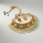 Studio flatlay of the gold-tone mint choker with matching earrings