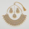Maharani Kundan Set gold-tone kundan choker with earrings and tikka on gray background