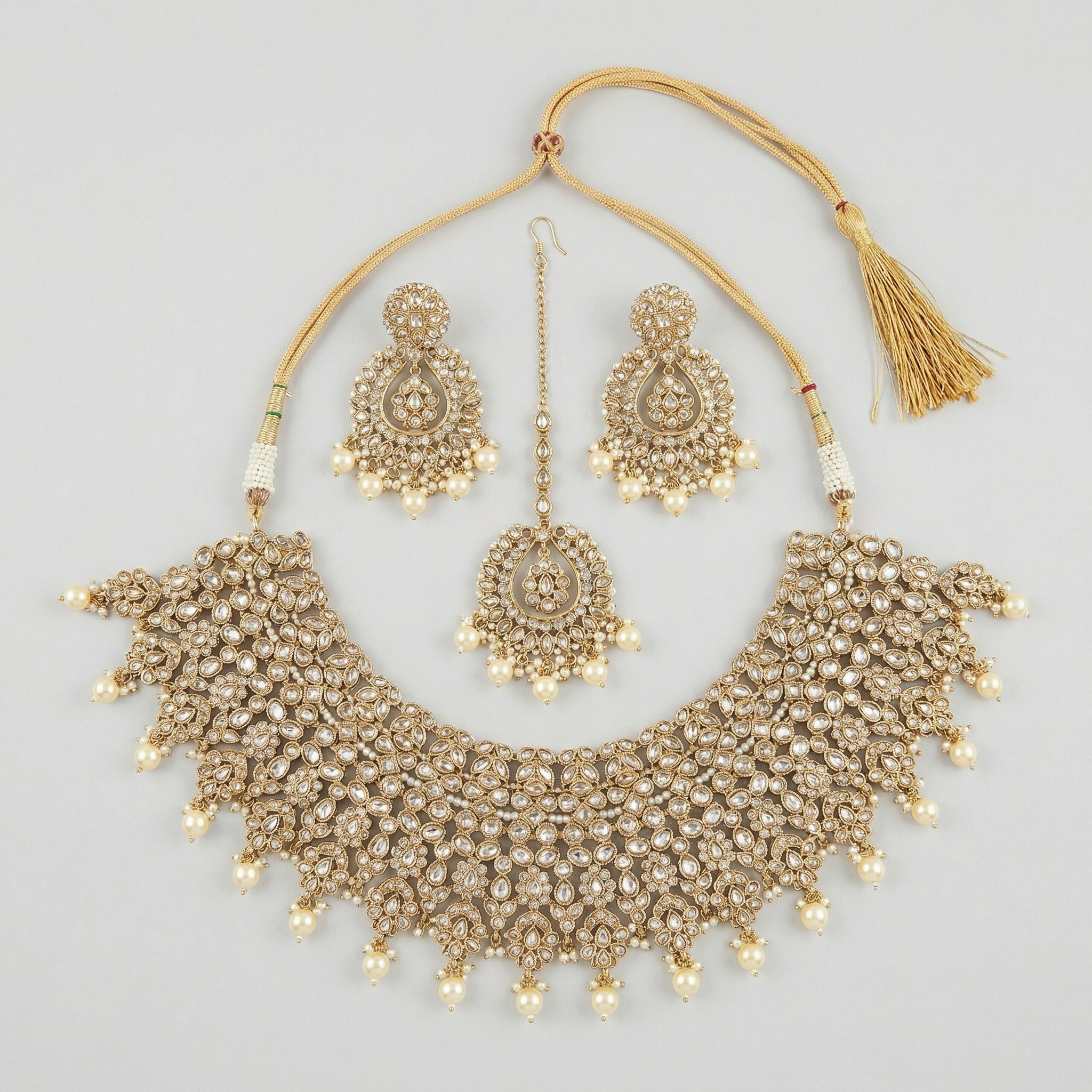 Maharani Kundan Set gold-tone kundan choker with earrings and tikka on gray background