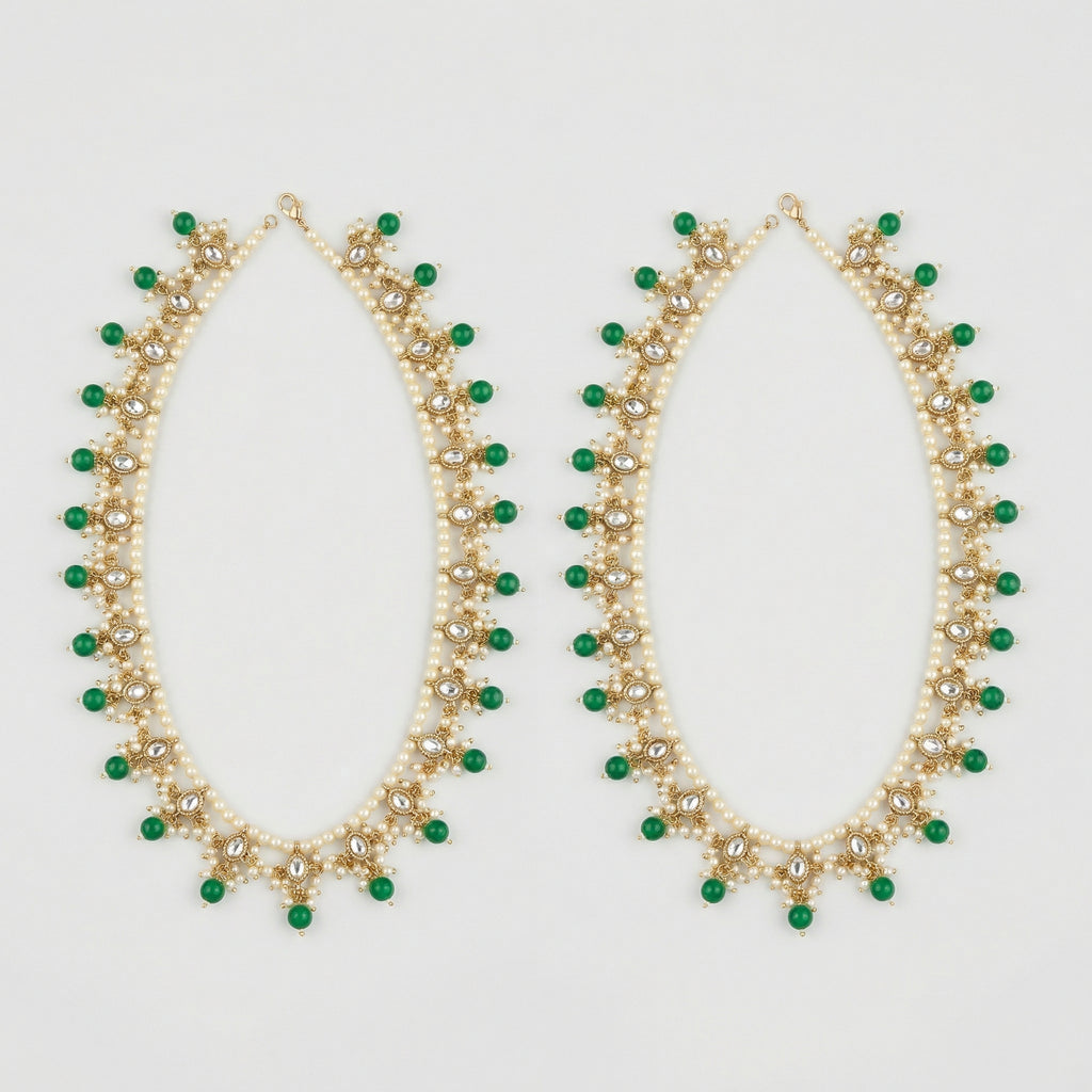 Emerald Pearl Anklets pair of gold-tone pearl payals with green drops and clear stones on gray background