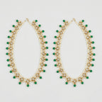 Emerald Pearl Anklets pair of gold-tone pearl payals with green drops and clear stones on gray background