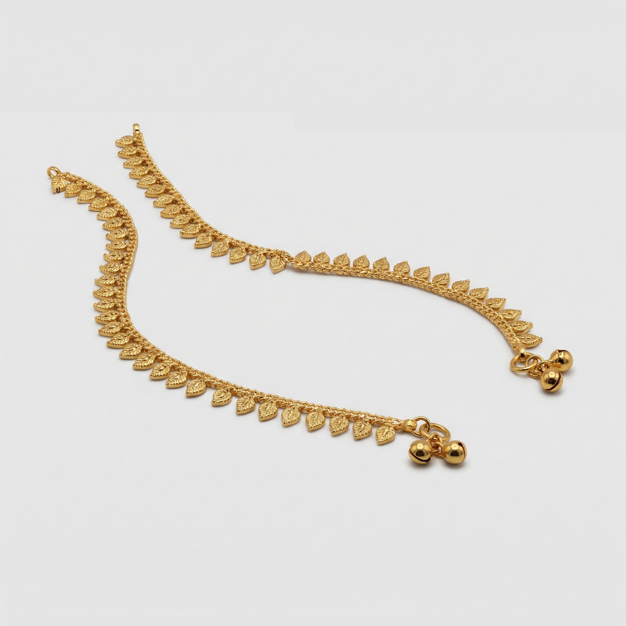 Golden Leaf Anklets detail showing veined leaf charms and polished gold finish