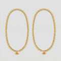 Golden Leaf Anklets pair of gold-tone leaf fringe payals with triple bead accent on gray background