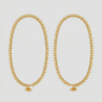 Golden Leaf Anklets pair of gold-tone leaf fringe payals with triple bead accent on gray background