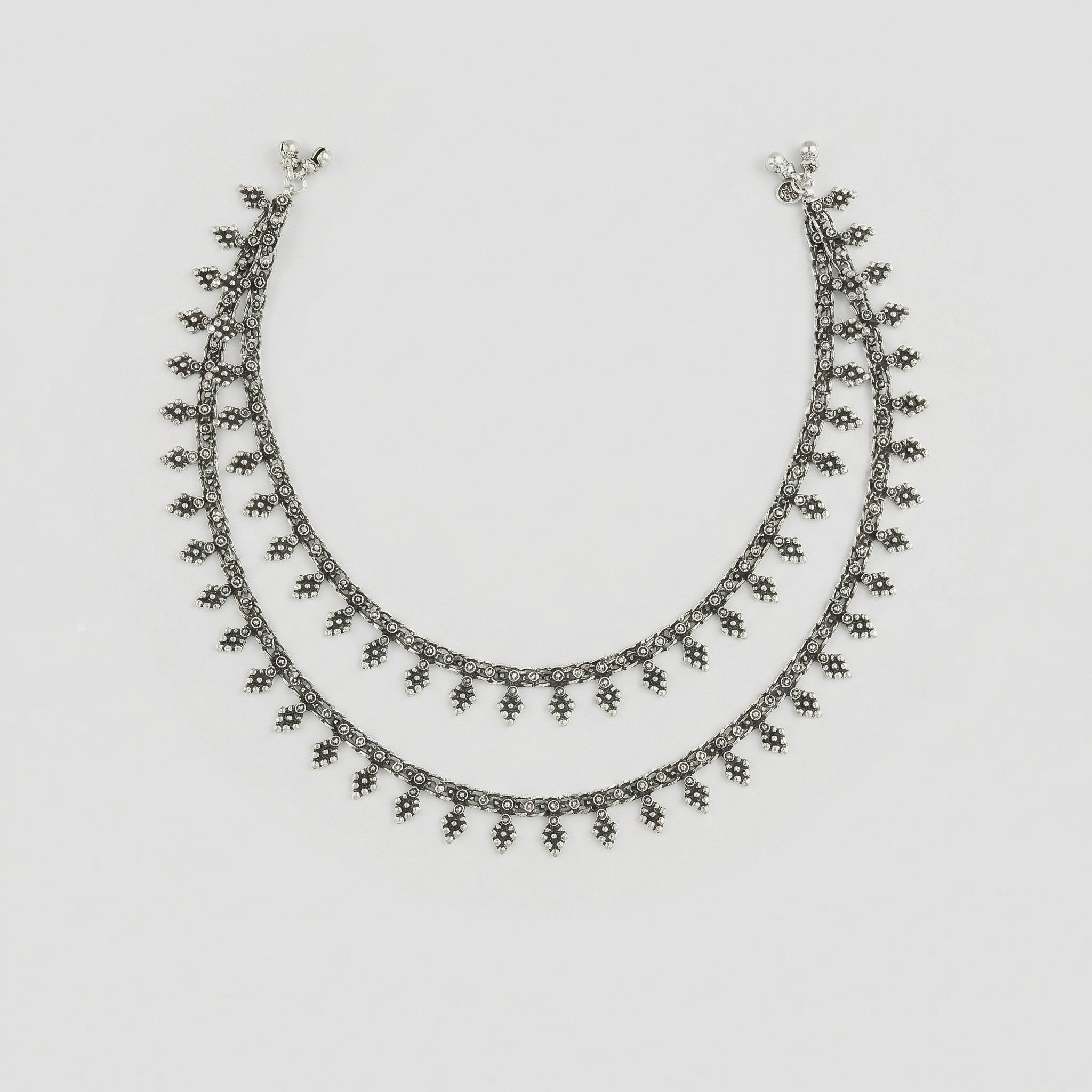 Silver Grapevine Anklets pair of oxidized silver leaf charm payals with ghungroo bells on gray background