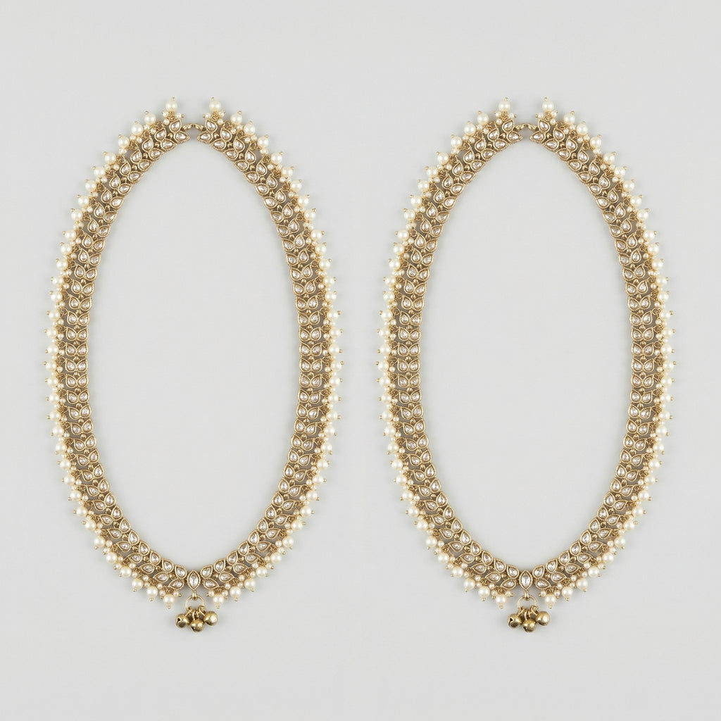 Kundan Pearl Payal pair of gold-tone pearl-bordered payals with ghungroo cluster on gray background