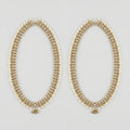Kundan Pearl Payal pair of gold-tone pearl-bordered payals with ghungroo cluster on gray background