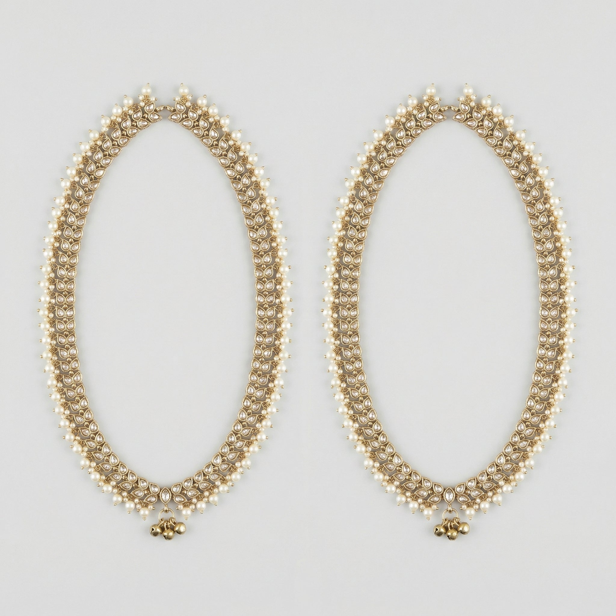 Kundan Pearl Payal pair of gold-tone pearl-bordered payals with ghungroo cluster on gray background