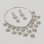 Close-up flatlay of Elegant Silver Statement Set necklace and matching earrings