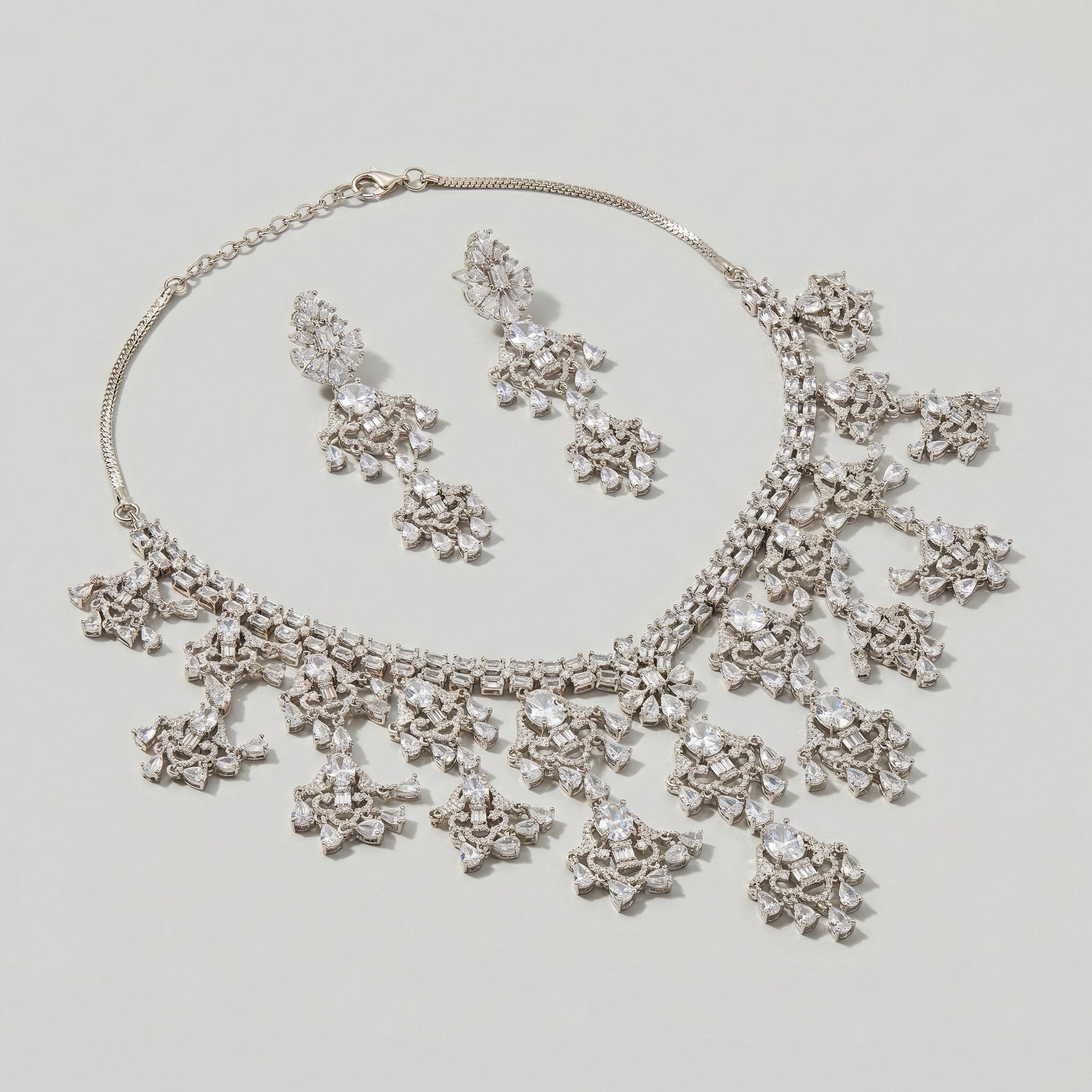 Close-up flatlay of Elegant Silver Statement Set necklace and matching earrings