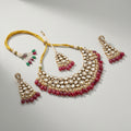 Studio flatlay of the red kundan necklace set with matching earrings.
