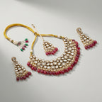Studio flatlay of the red kundan necklace set with matching earrings.