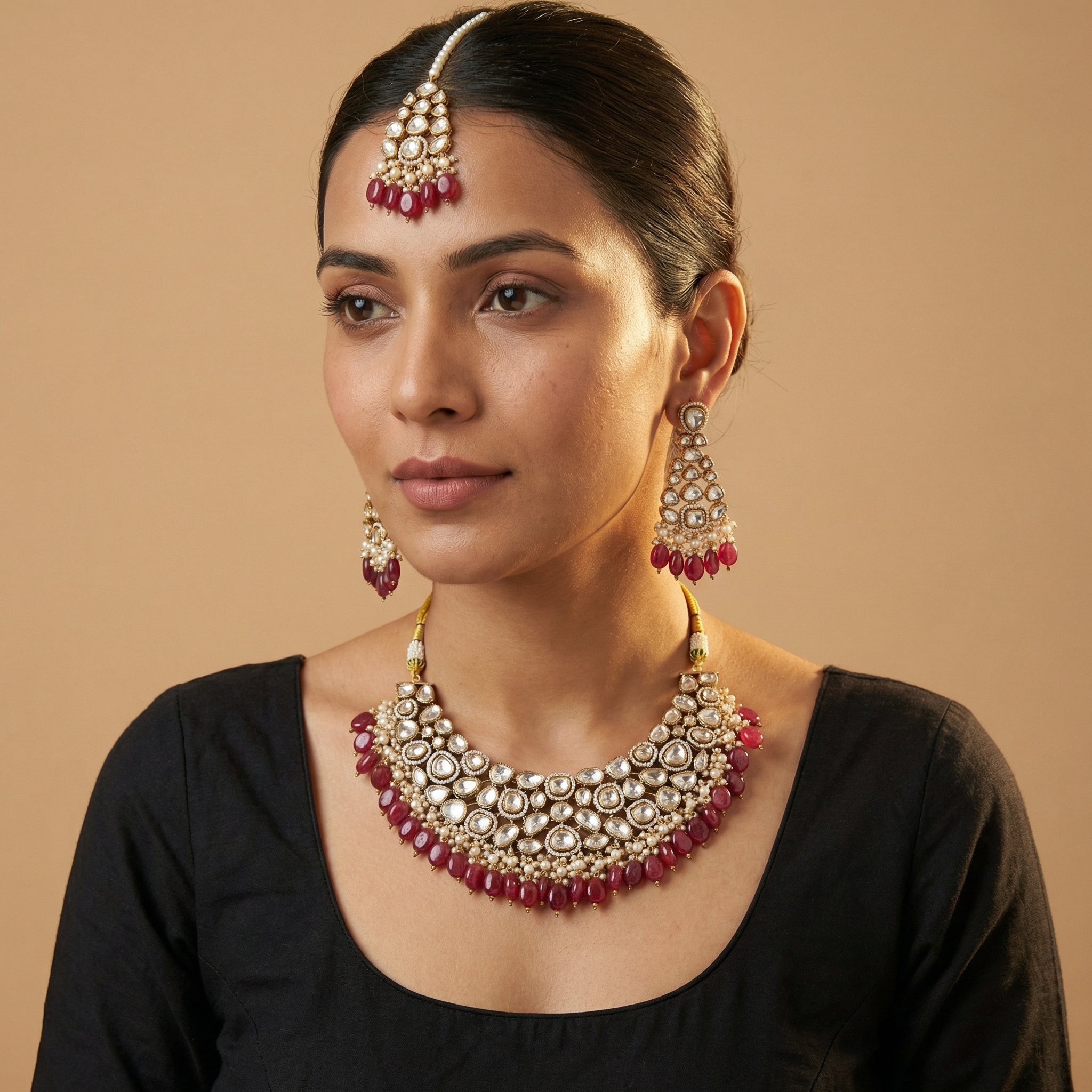 South Asian woman wearing the red kundan necklace set — bridal look.