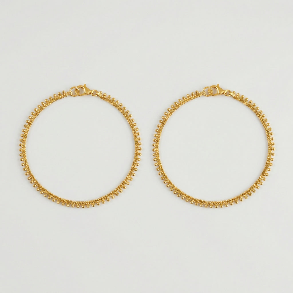 Golden Dotted Chain Anklets pair of gold twisted-chain payals with bead fringe on gray background