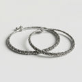 Oxidized Floral Anklets pair of antique silver rigid kada payals with floral filigree on gray background