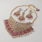 Meera Ruby Radiance Set detail showing ruby-pink stone band, pearl fringe, and crystal filigree work
