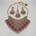 Meera Ruby Radiance Set silver bib necklace with pink stones, chandelier earrings, and maang tikka on gray background