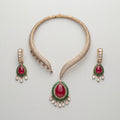 Ruby Emerald Majesty Set gold collar necklace with ruby-emerald pendant and matching drop earrings on gray background