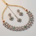 Amara Multi-Stone Choker Set silver polki collar with green pink and peach stones, earrings, and maang tikka on gray background