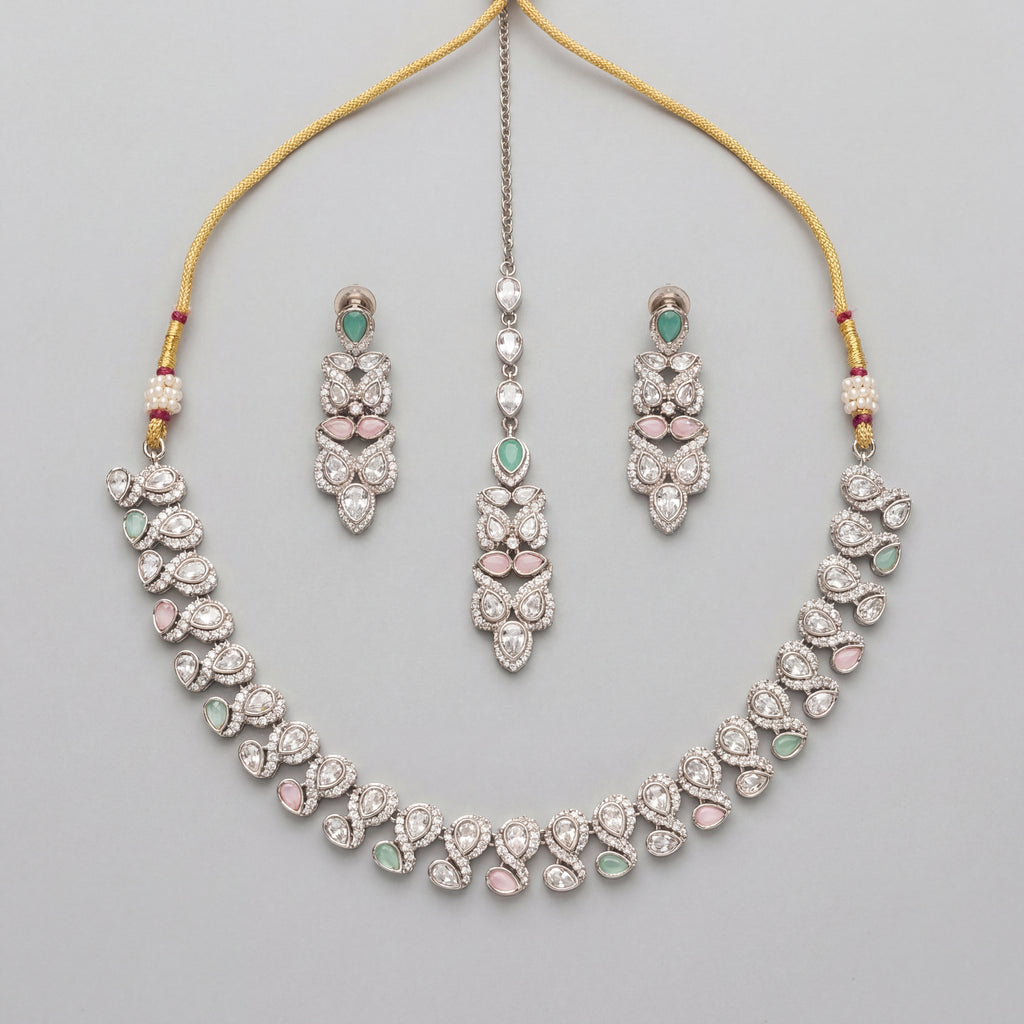 Aria Pastel Necklace Set silver collar necklace with mint and pink stones, earrings, and maang tikka on gray background