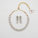 Elara Silver Polki Set silver oval polki collar necklace with matching drop earrings on gray background