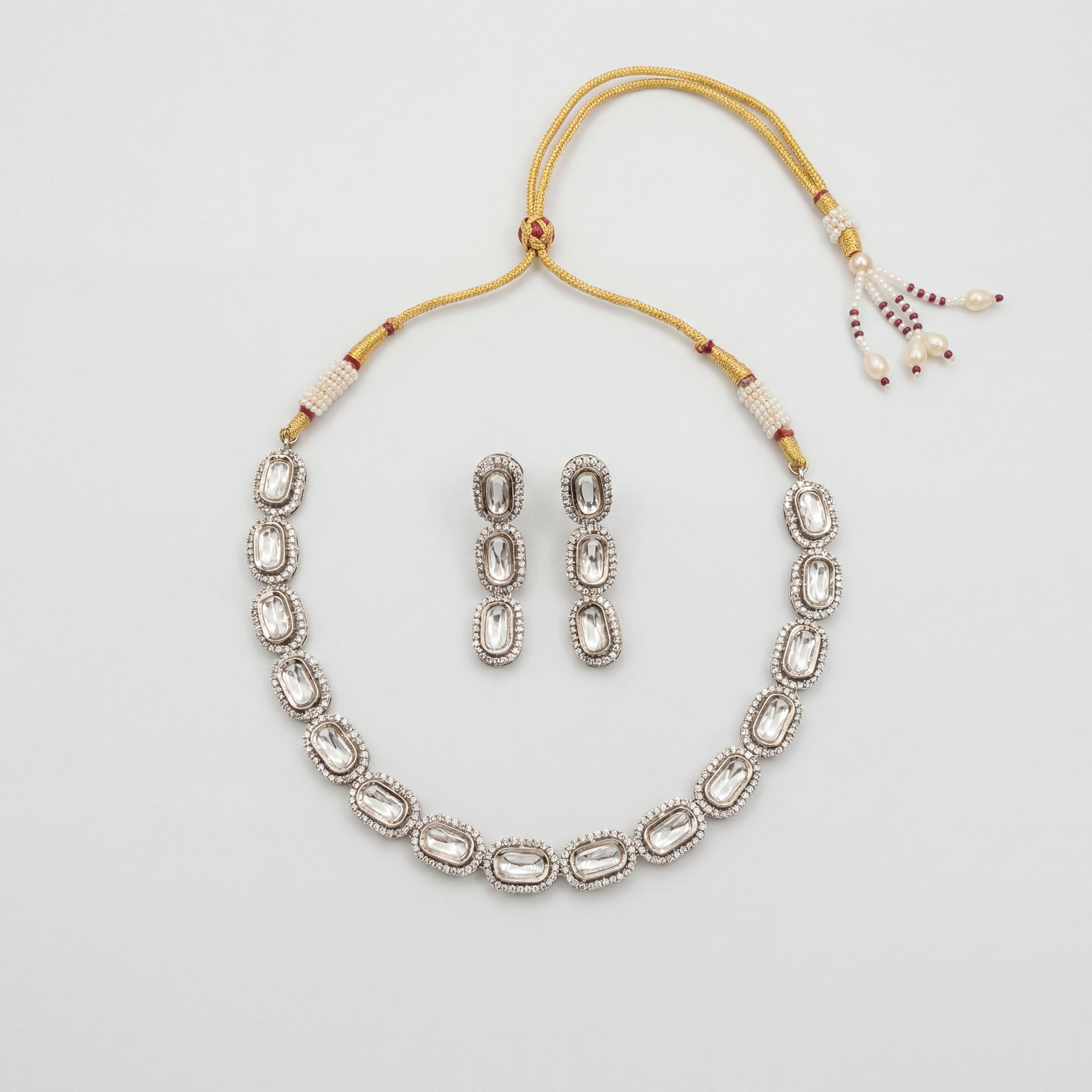 Elara Silver Polki Set silver oval polki collar necklace with matching drop earrings on gray background