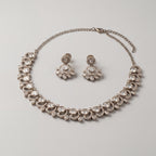 Aria Crystal Necklace Set detail showing clear flat-cut polki stones, crescent halos, and pear-shaped drops