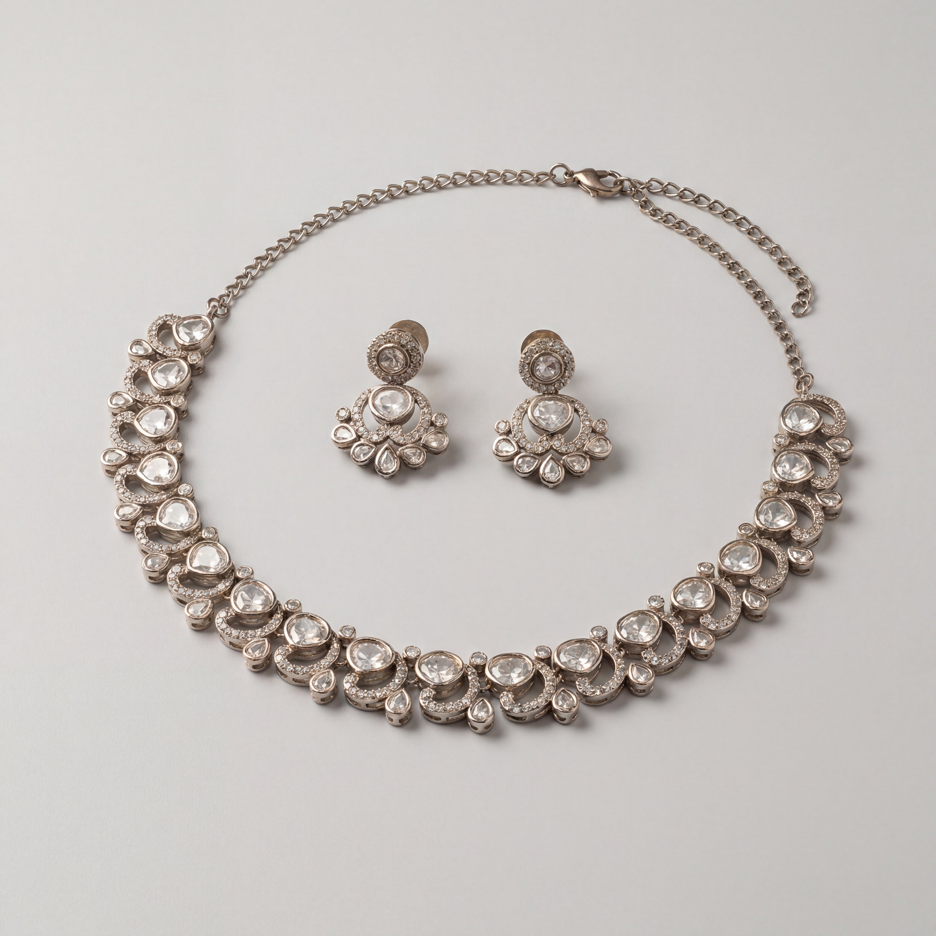 Aria Crystal Necklace Set detail showing clear flat-cut polki stones, crescent halos, and pear-shaped drops