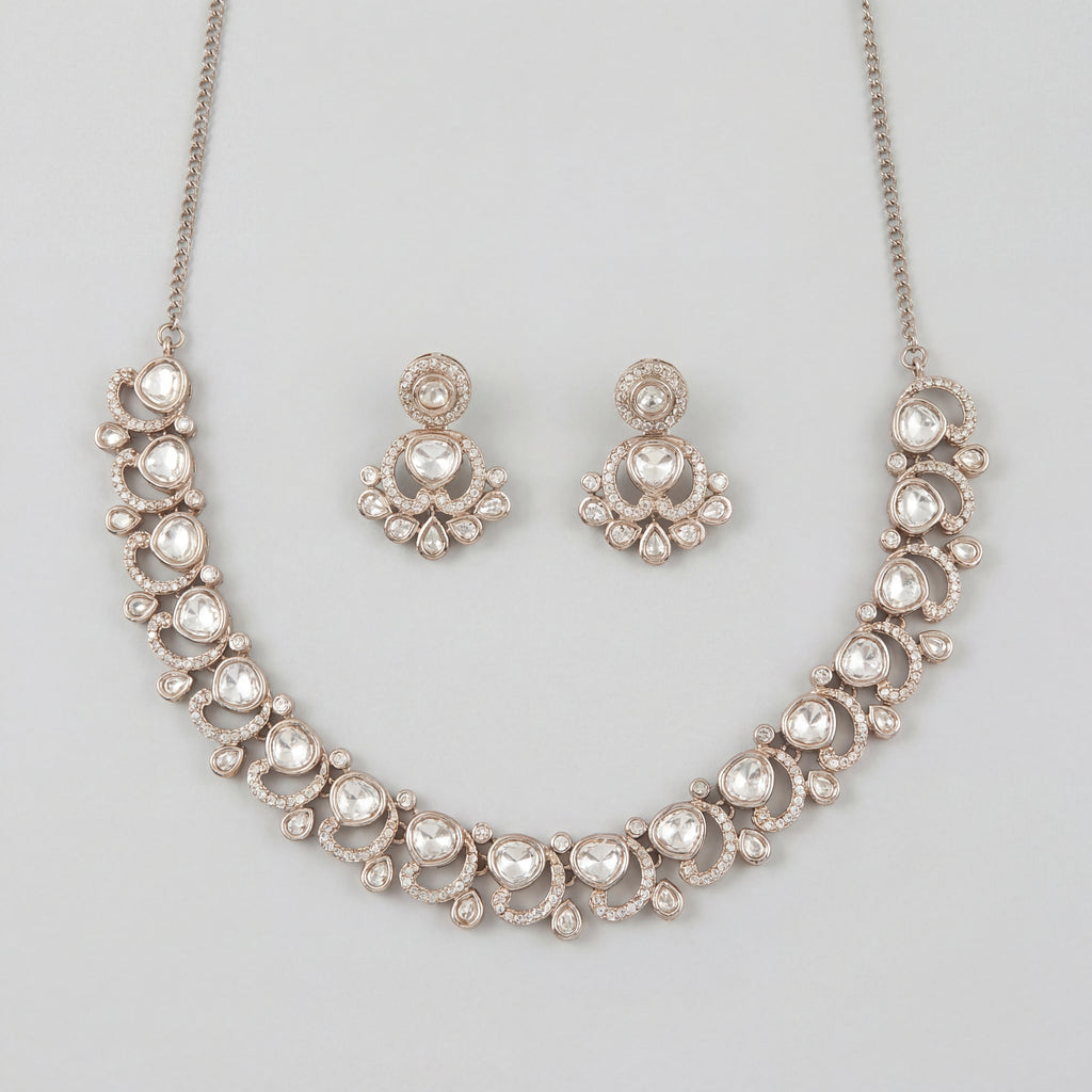 Aria Crystal Necklace Set silver polki collar necklace with matching chandelier drop earrings on gray background