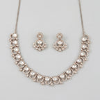 Aria Crystal Necklace Set silver polki collar necklace with matching chandelier drop earrings on gray background