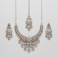 Aria Silver Necklace Set antique silver bib collar with chandelier earrings and maang tikka on gray background