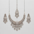 Aria Silver Necklace Set antique silver bib collar with chandelier earrings and maang tikka on gray background