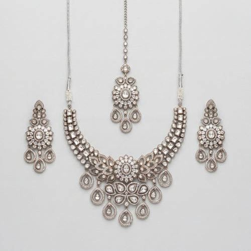 Aria Silver Necklace Set antique silver bib collar with chandelier earrings and maang tikka on gray background